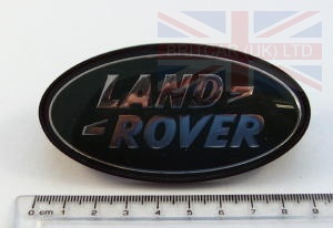 Image of MXC6402, a 'BADGE - LAND ROVER - GREEN + GOLD - FRONT GRILLE - DEFENDER' part