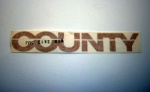 DECAL - COUNTY - BEIGE - BODY SIDE - DEFENDER FROM VIN JA